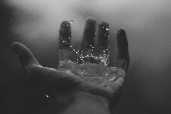 Hand water drop black and white Photo