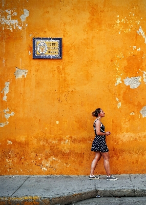 Person woman sidewalk wall Photo