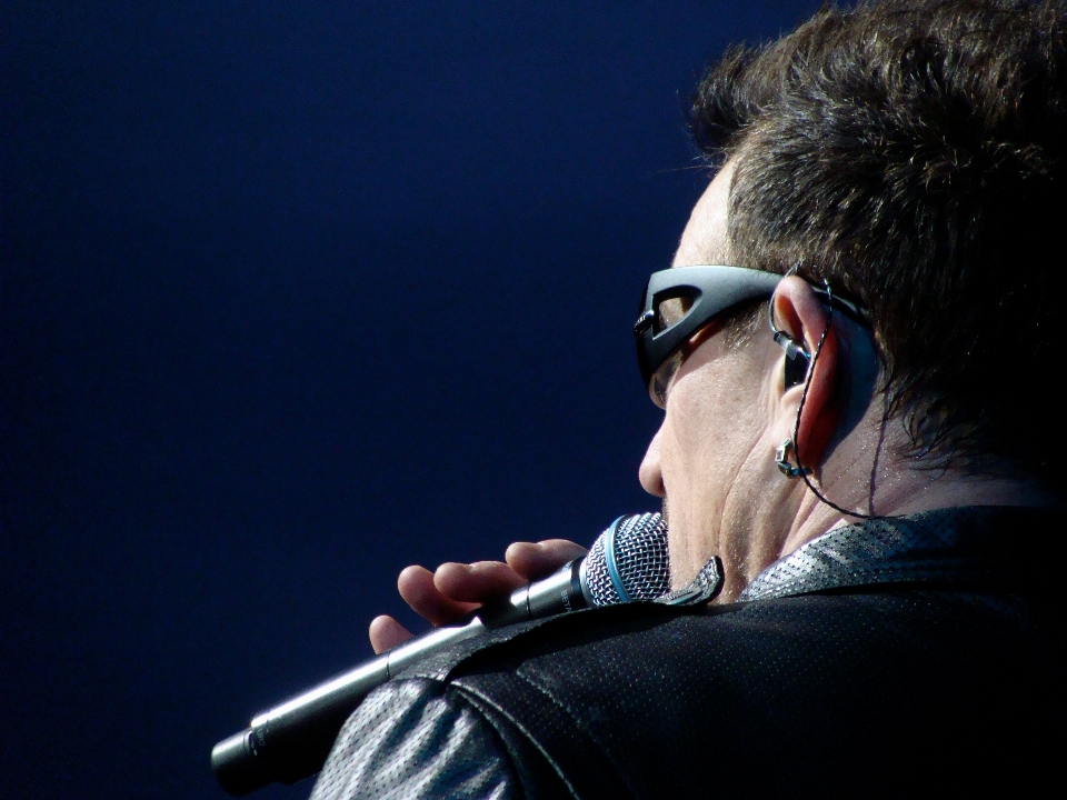 Person singer microphone bono