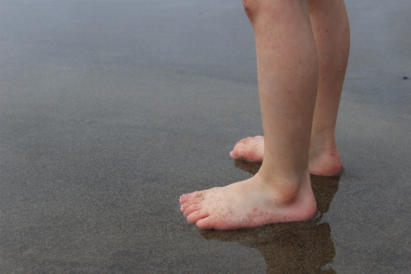 Hand sand shoe leg Photo