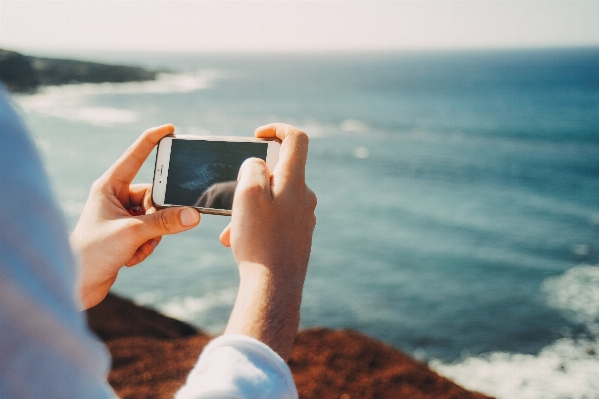 Iphone hand man beach Photo