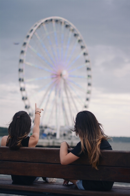 Woman point big wheel friend