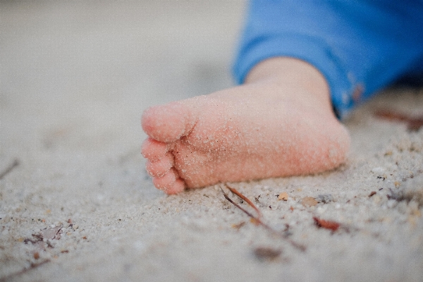 Hand sand kid leg Photo