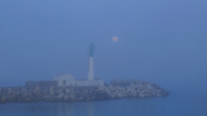 Sea water lighthouse fog Photo