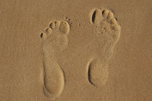 Foto Mão praia areia pegada