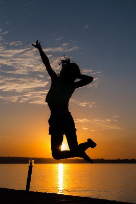 Sea silhouette girl sunrise Photo