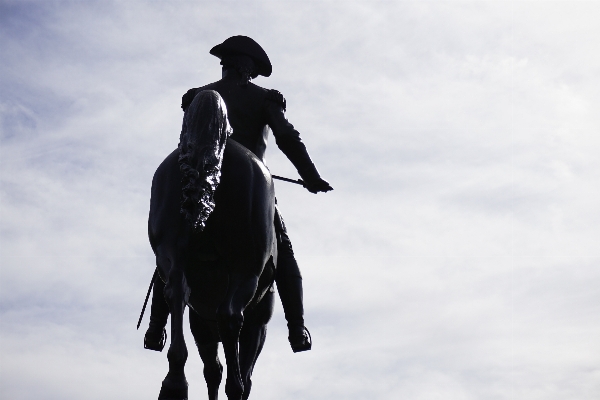 Foto Bayangan hitam monumen melompat patung