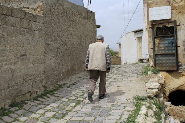 Man walking street town Photo