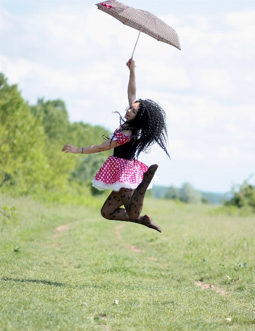 Girl jumping umbrella flight