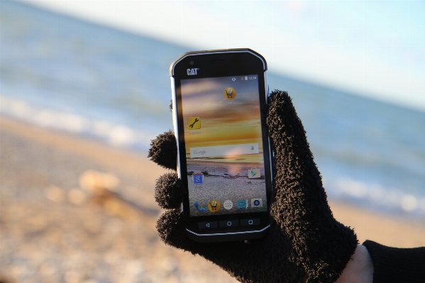 Smartphone hand beach sea Photo