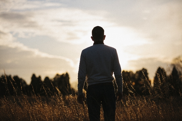 Man grass horizon silhouette Photo