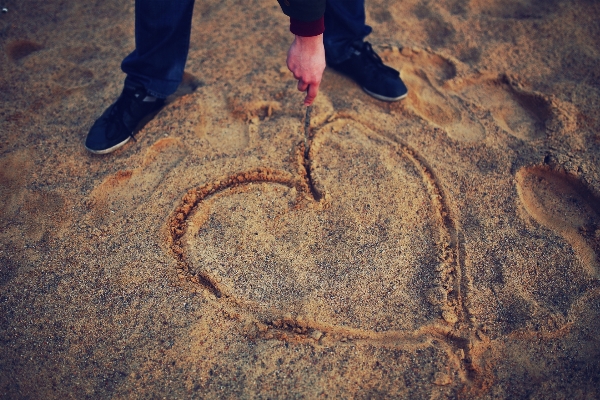 Hand man beach sand Photo