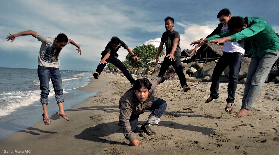 Beach group people jump