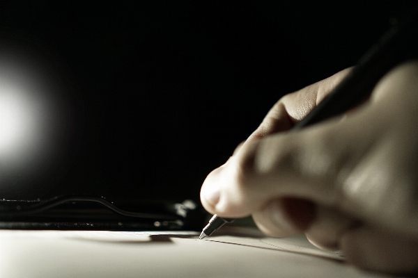 Writing hand light night Photo