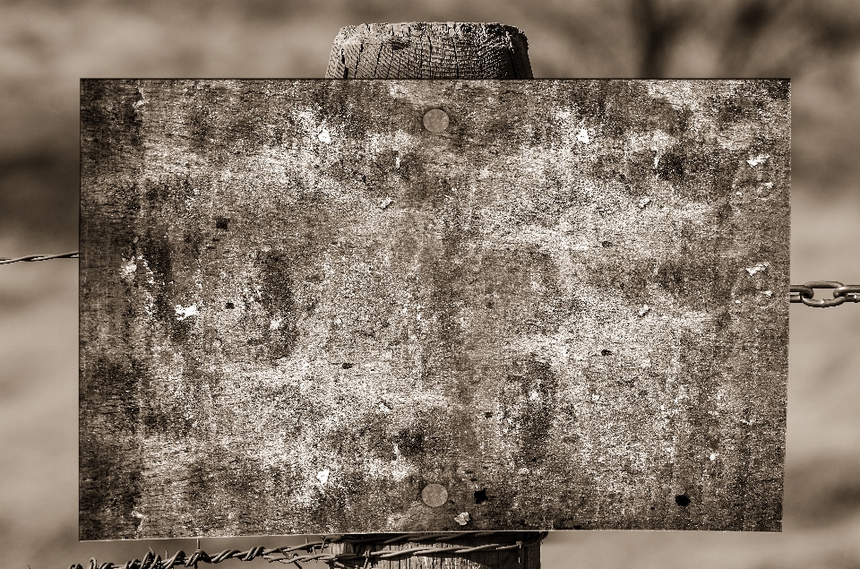 Rock fence barbed wire post