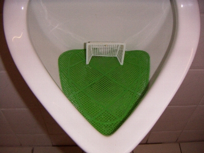 Green surfboard toilet football Photo