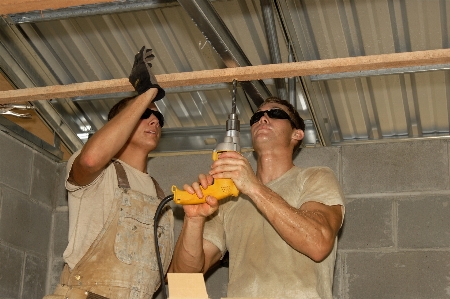 Person building ceiling construction Photo