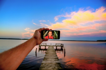 Smartphone hand beach landscape Photo