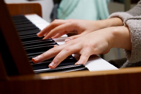 Writing hand music keyboard Photo