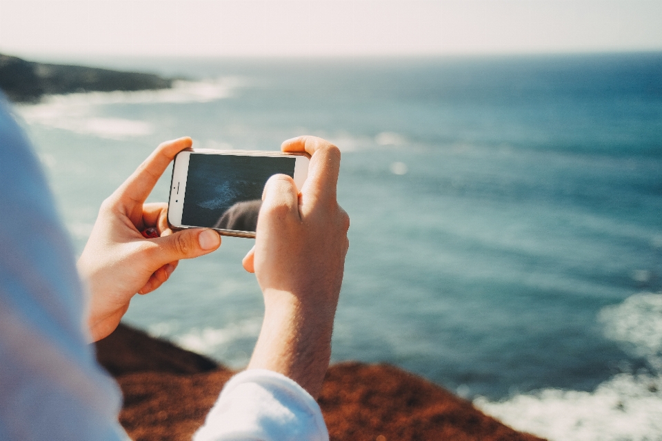 Iphone smartphone mano spiaggia