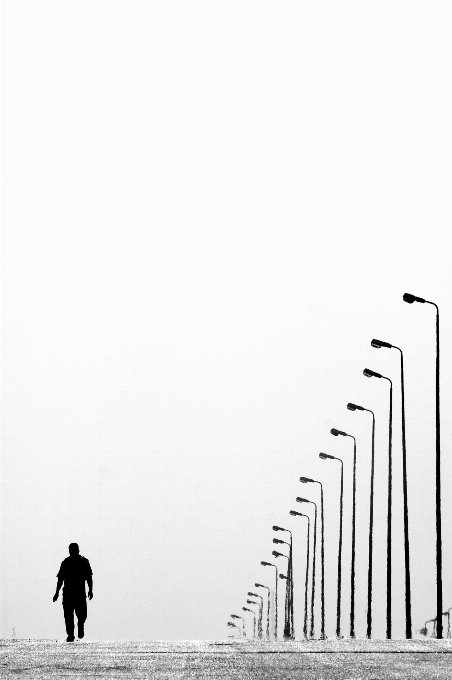 Man walking black and white road