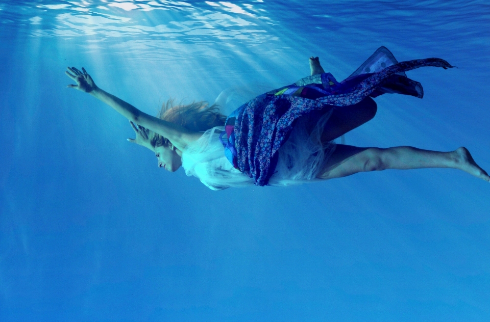 Sea girl diving underwater