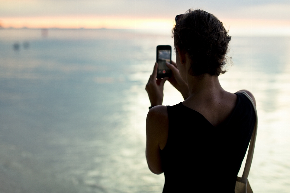 Smartphone hand man beach