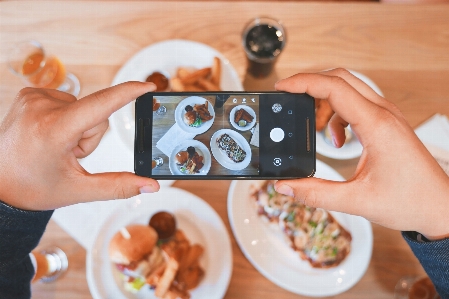 Smartphone hand table photographer Photo