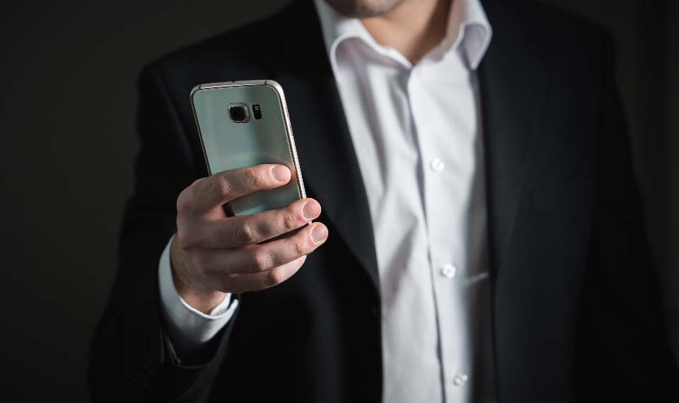 Smartphone hand man suit