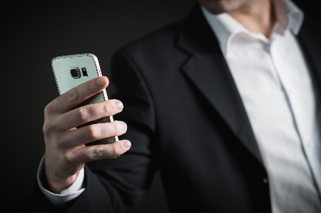 Smartphone hand man suit Photo