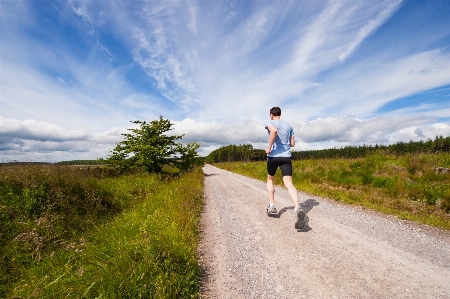 Man walking mountain trail Photo