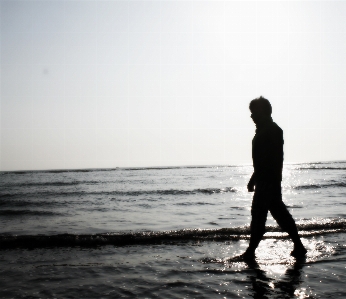 Man beach sea coast Photo