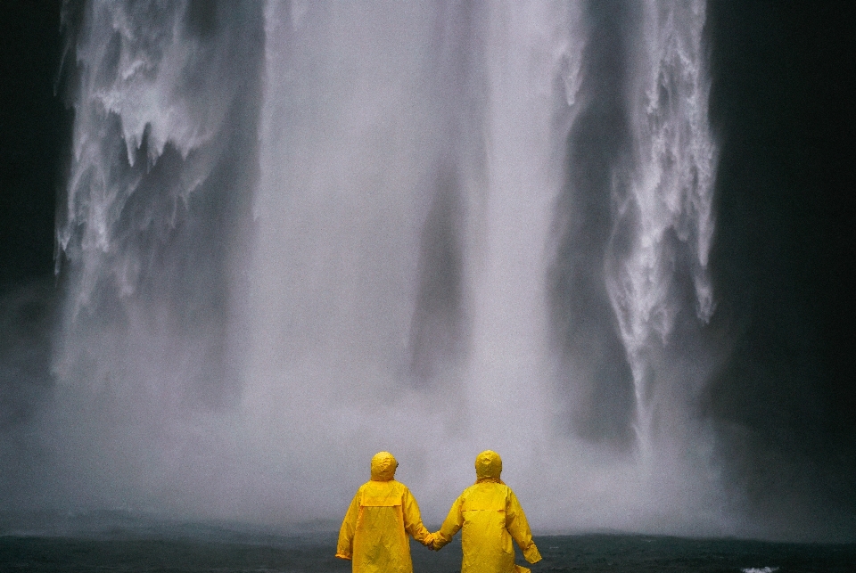 Couple holding hands people raincoat