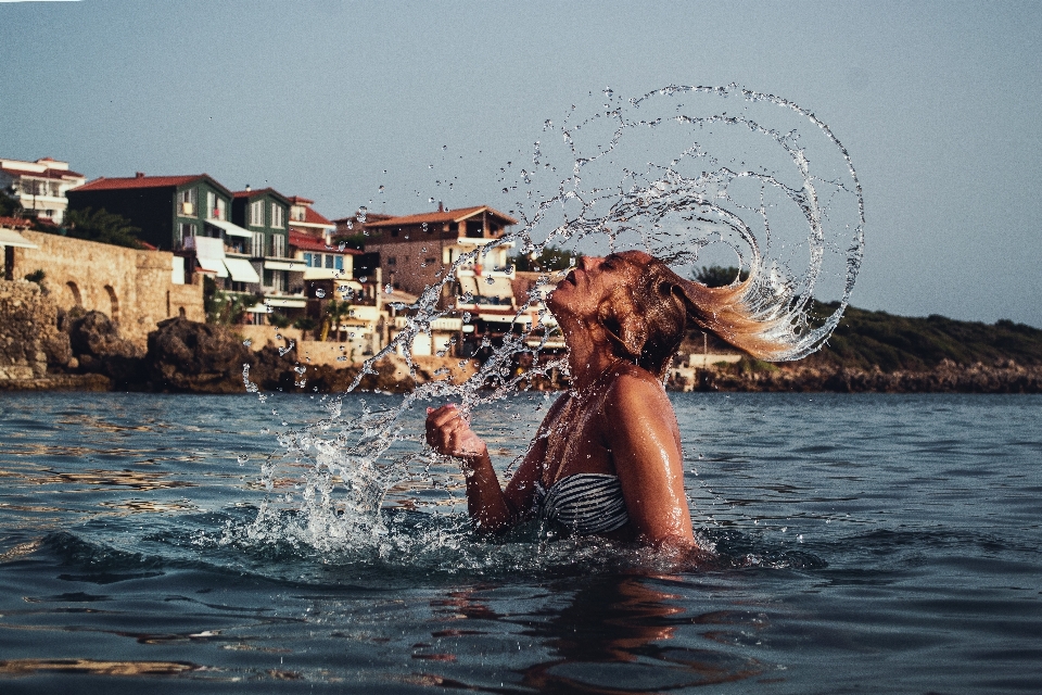 Water splash with hair beautiful girl seaside portrait motion