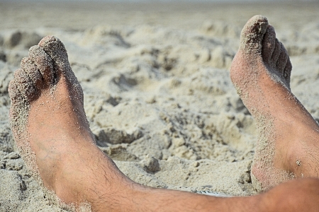 Hand beach sand rock Photo