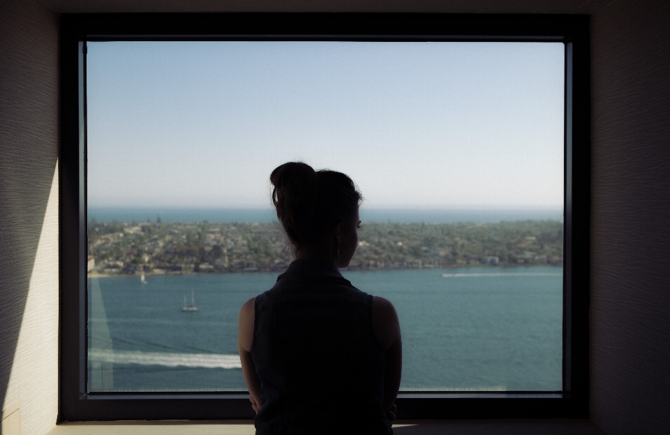 Sea silhouette woman window