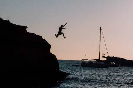 Cliff man jumping diving Photo