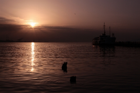 Sunset waterway body of water Photo