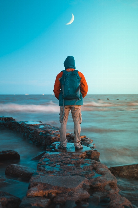 Man ocean coast moon