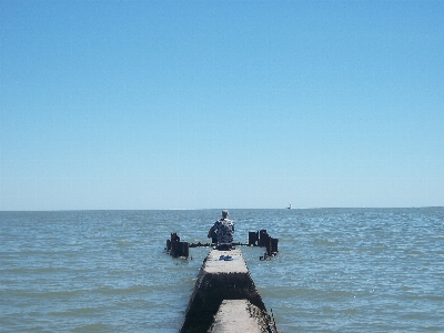 Man sea water sky Photo