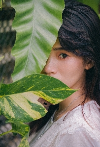 Beautiful girl green leaf Photo