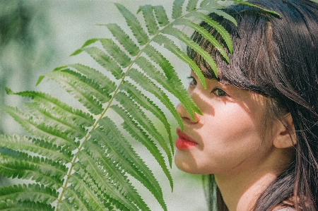 Beautiful girl green leaf Photo