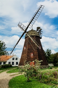 Windmill clouds house garden Photo