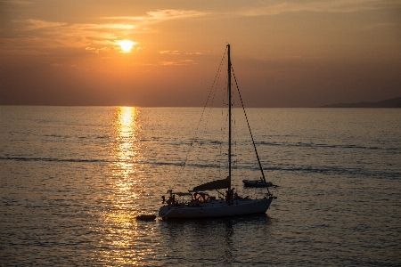 Sunset sea boat sun Photo