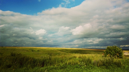 Sky clouds blue land Photo