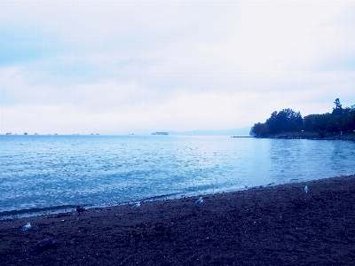 Foto Océano playa lloviendo azul