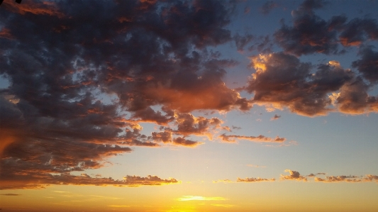 Sunrise clouds blue gold Photo