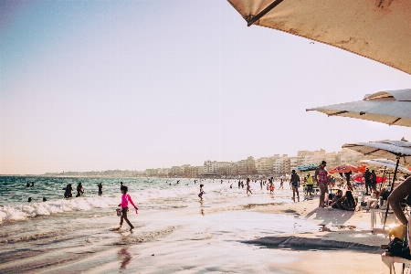 People on beach sky umbrella Photo