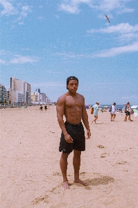 People on beach sand barechested Photo