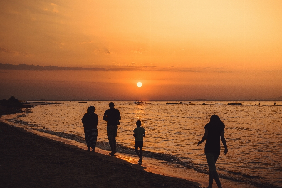 People on beach sky horizon